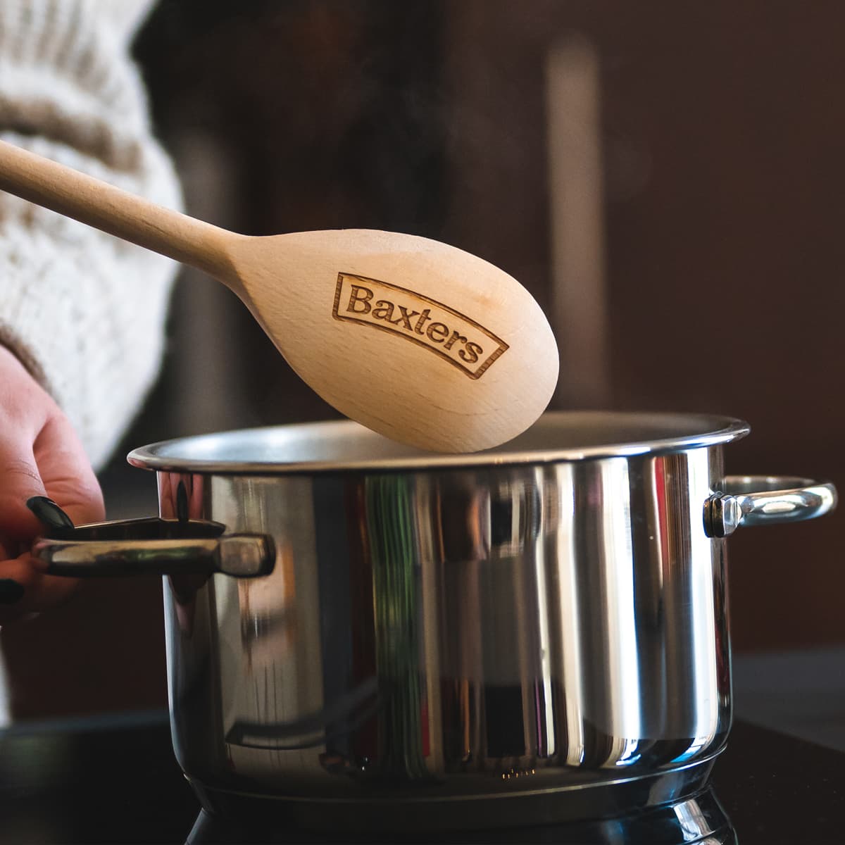 A Baxters wooden spoon being used to cook soup