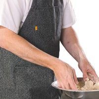 A chef wearing a Trakke Apron while working dough